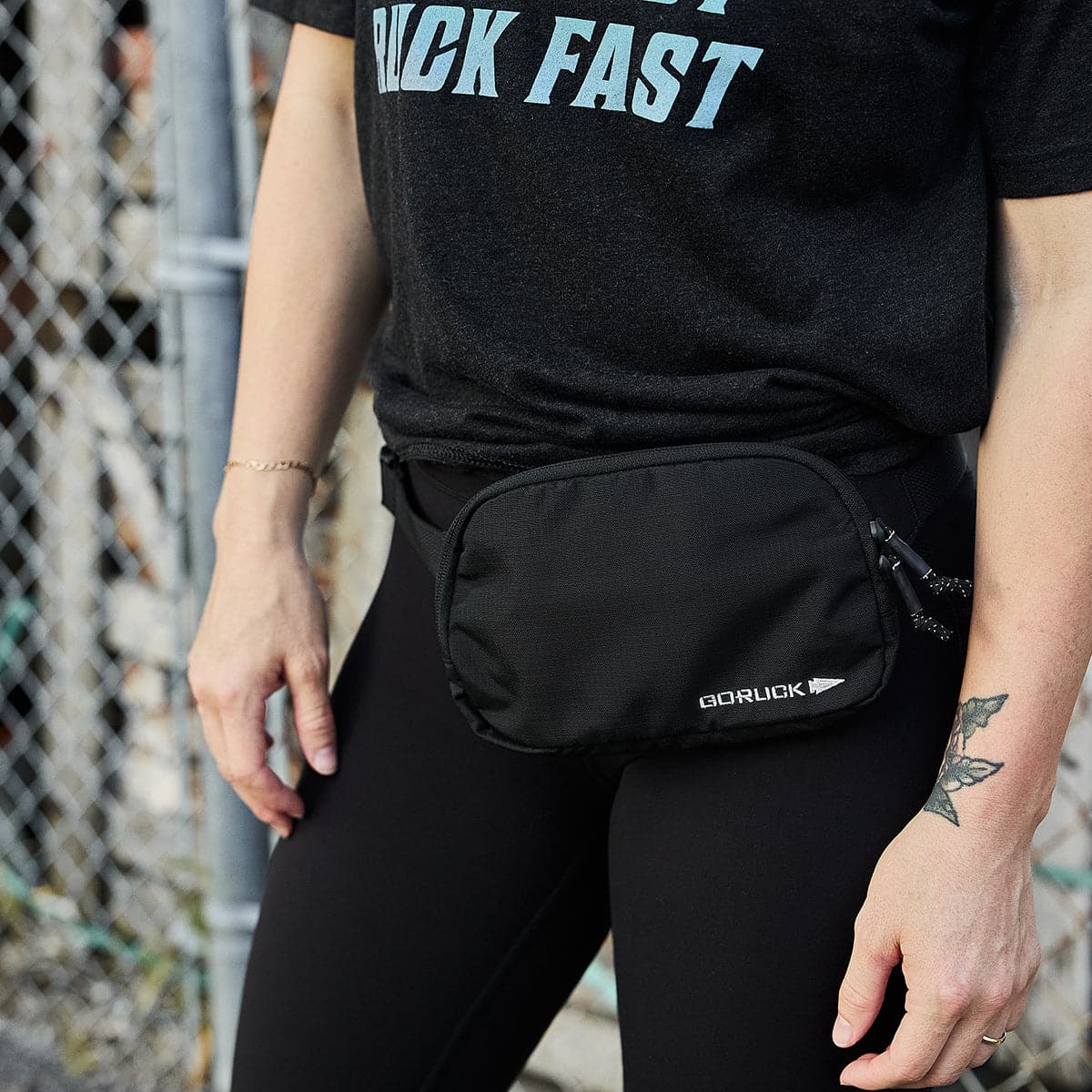 GORUCK black belt bag worn outdoors, durable rucking gear on person in athletic wear