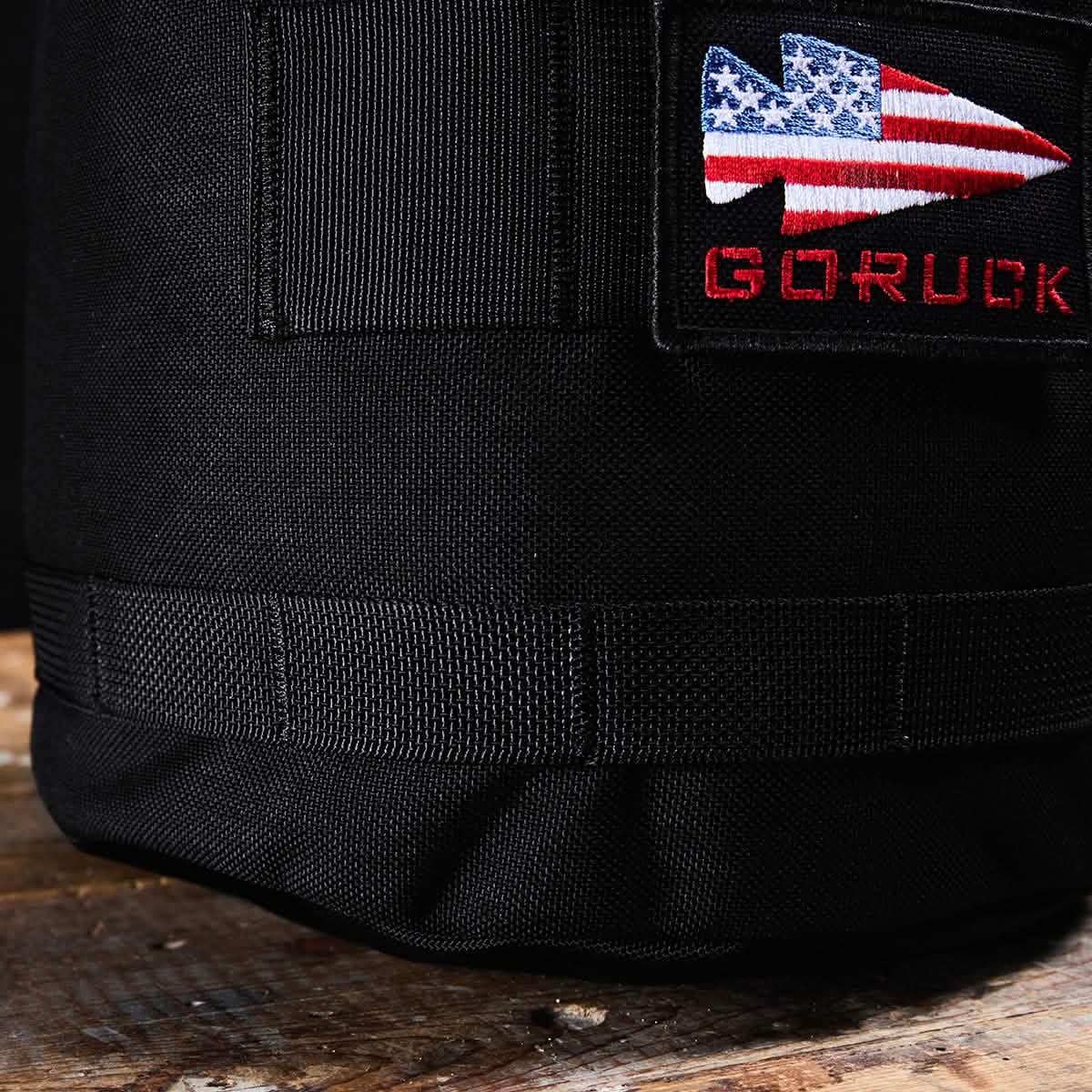 Close-up of a GORUCK Brick Bag (5-50 LBS) in black, featuring a patch with a US flag arrow and 