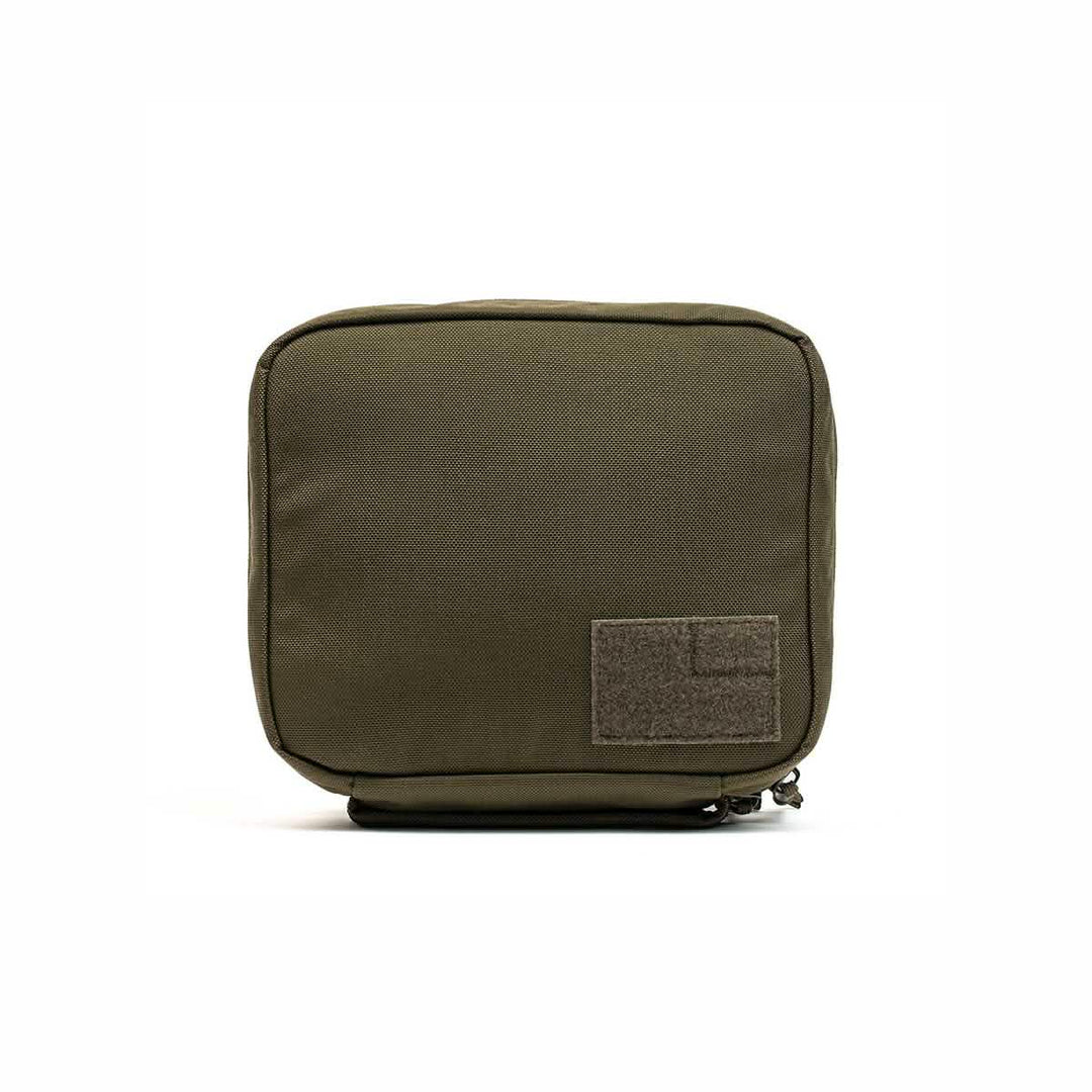 The GORUCK GR2 Field Pocket is an olive green rectangular Cordura pouch with a zipper and a front patch, perfect as an electronics organizer, shown on a white background.