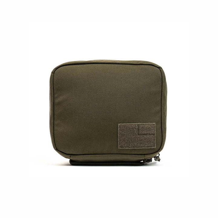 The GORUCK GR2 Field Pocket is an olive green rectangular Cordura pouch with a zipper and a front patch, perfect as an electronics organizer, shown on a white background.