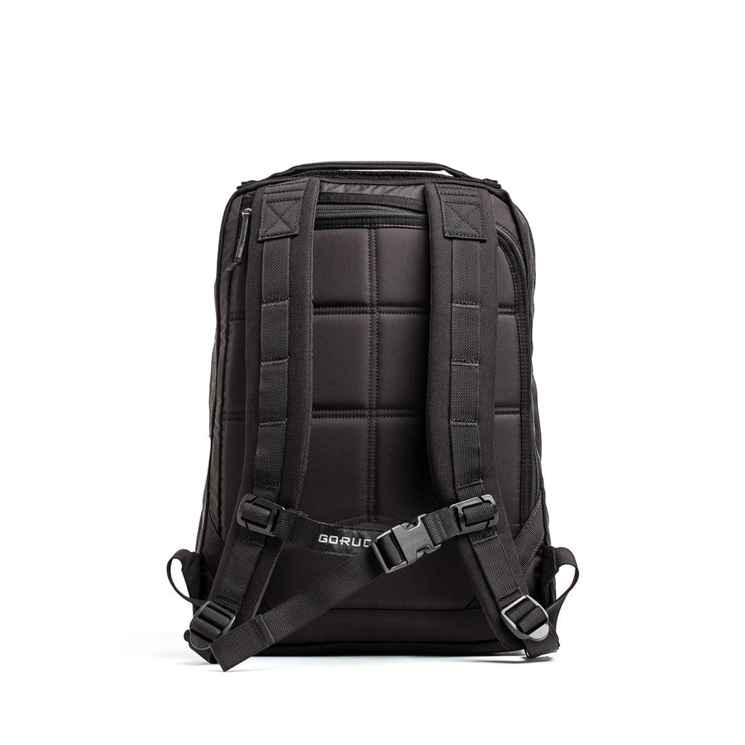 Displayed on a simple white backdrop is the GR0 - Cordura, a sleek black backpack featuring a bombproof laptop compartment, padded shoulder straps, and a sternum strap. Its cushioned back panel ensures comfort, while the GORUCK logo at the bottom highlights its status as an ideal minimalist EDC selection.