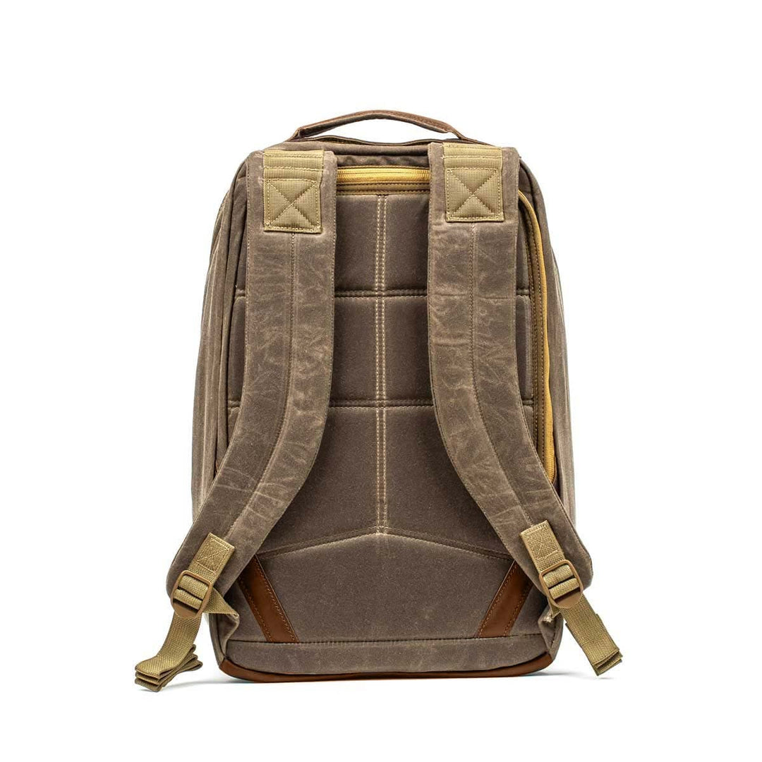 The GR1 USA - Heritage by GORUCK is a brown waxed duck canvas rucksack showcasing a back view with padded shoulder straps and a top handle.