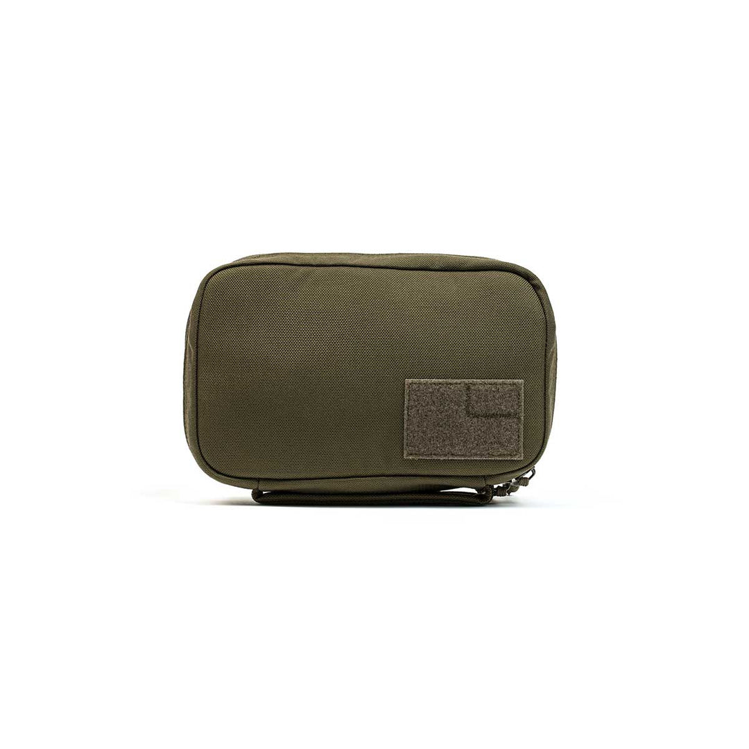 The GR1 Field Pocket by GORUCK is an olive green, rectangular pouch equipped with a zipper and a small Velcro patch on the front, making it ideal for use as an electronics organizer.