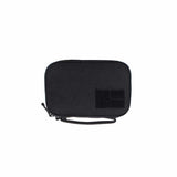 The GORUCK GR1 Field Pocket, with its sleek black rectangular design, comes equipped with a zippered closure, wrist strap, and front velcro patch, making it perfect for use as an electronics organizer.