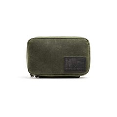 The GORUCK GR1 Field Pocket - Waxed Canvas is an olive green rectangular pouch featuring a black patch logo on the front, shown against a white background.