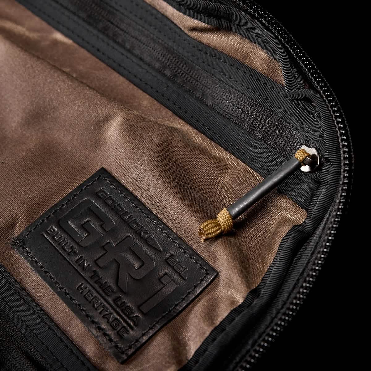 Close-up of the GR1 USA - Heritage by GORUCK, showcasing the brown interior with a zipper pocket and a 