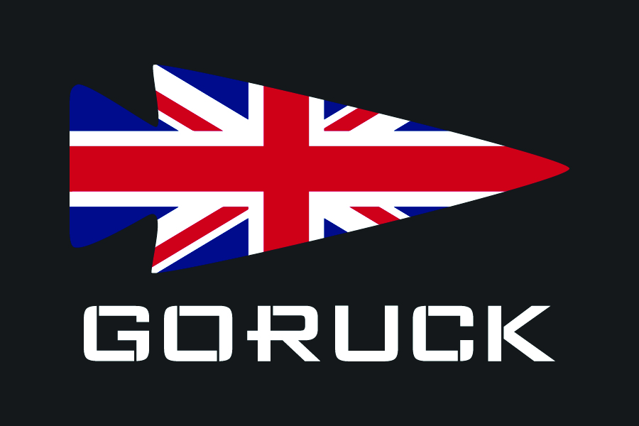 The Patch - UK by GORUCK features an arrowhead with a Union Jack flag design above the brand name “GORUCK” in bold white letters on a black background.