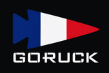 A stylized arrow featuring a blue, white, and red pattern is displayed above the bold, white “GORUCK” brand name on the Patch - France.