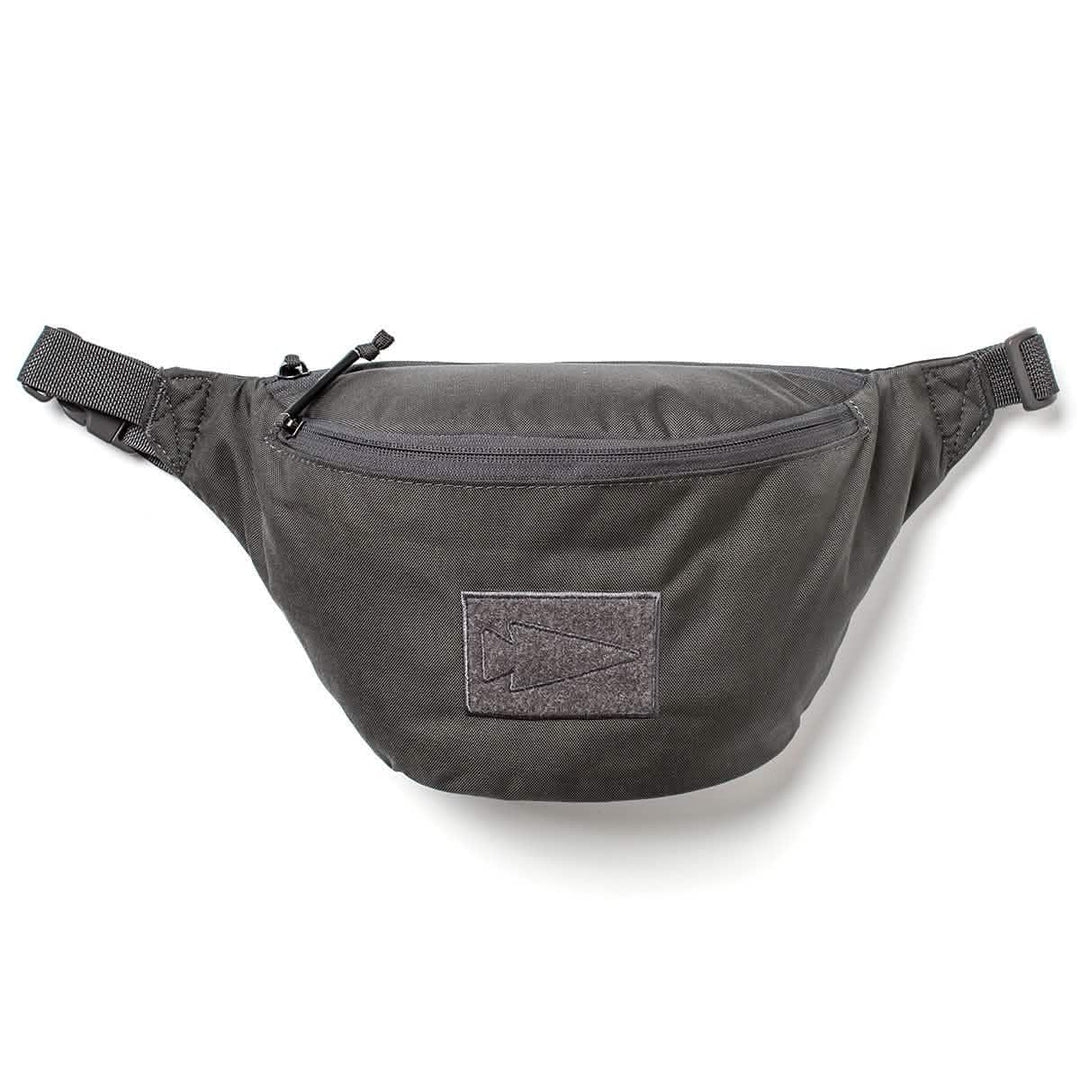 GORUCK black tactical fanny pack with zippered front pocket and arrowhead patch on a white background