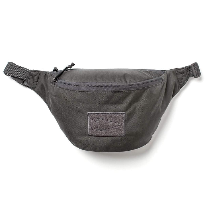 GORUCK black tactical fanny pack with zippered front pocket and arrowhead patch on a white background