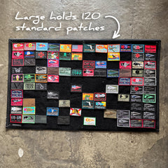GORUCK large patch board on concrete, displaying colorful rucking gear patches, holds 120 patches