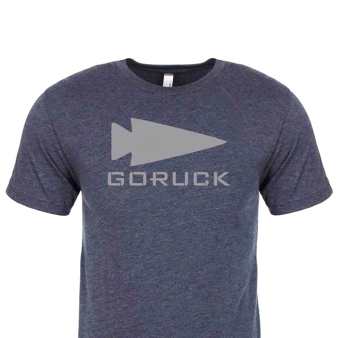 The Three Rules Tee - Tri-Blend by vendor-unknown is a dark blue premium shirt with a gray arrow and "GORUCK" text on the front—ideal for photos or daily wear.