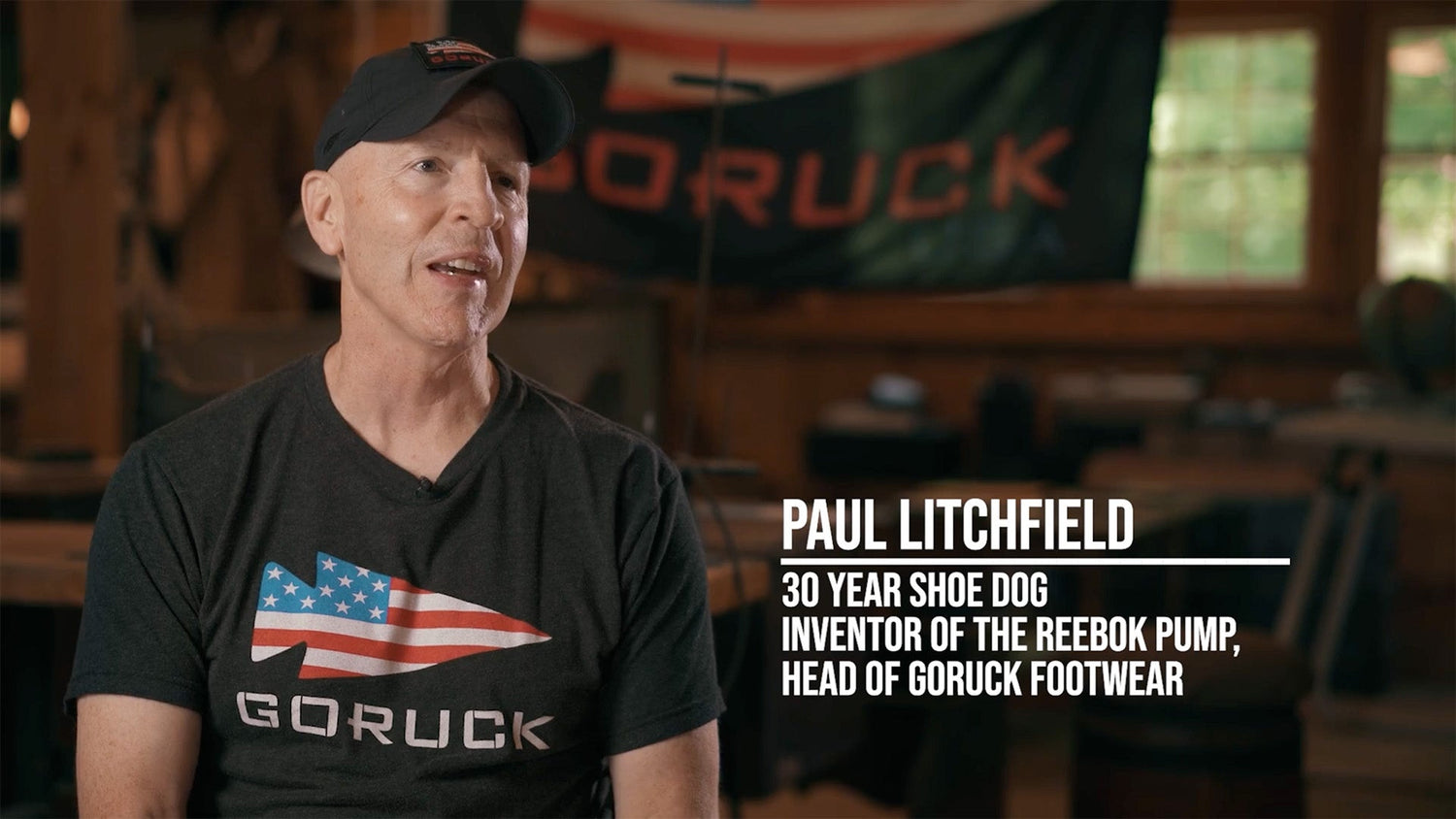 Man in a GORUCK shirt and hat sits indoors, text identifies him as Paul Litchfield, shoe designer and executive.