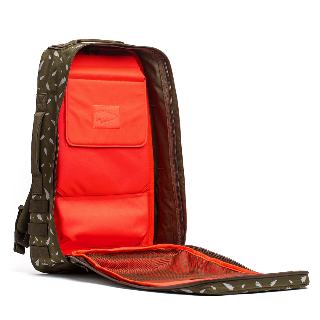 The Rucker 4.0 by GORUCK, in an open green design, unveils an orange interior adorned with a striking geometric pattern, making it ideal for rucking enthusiasts.