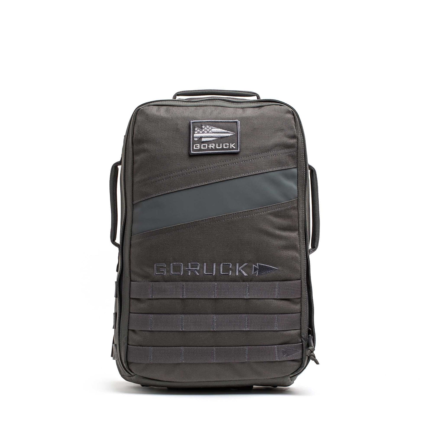 The Rucker 5.0, a black GORUCK rucksack with a front patch and multiple handles, designed for rucking, stands upright on a white background.