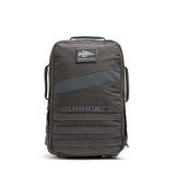 The Rucker 5.0, a black GORUCK rucksack with a front patch and multiple handles, designed for rucking, stands upright on a white background.