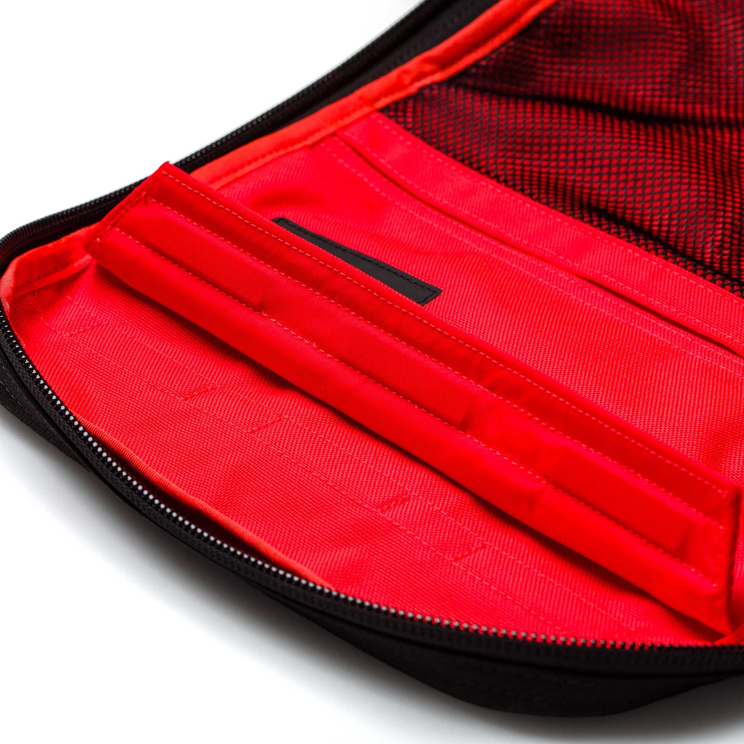 Close-up of an open Rucker 5.0 in red and black, highlighting multiple interior pockets and compartments—ideal for organizing your rucking essentials.