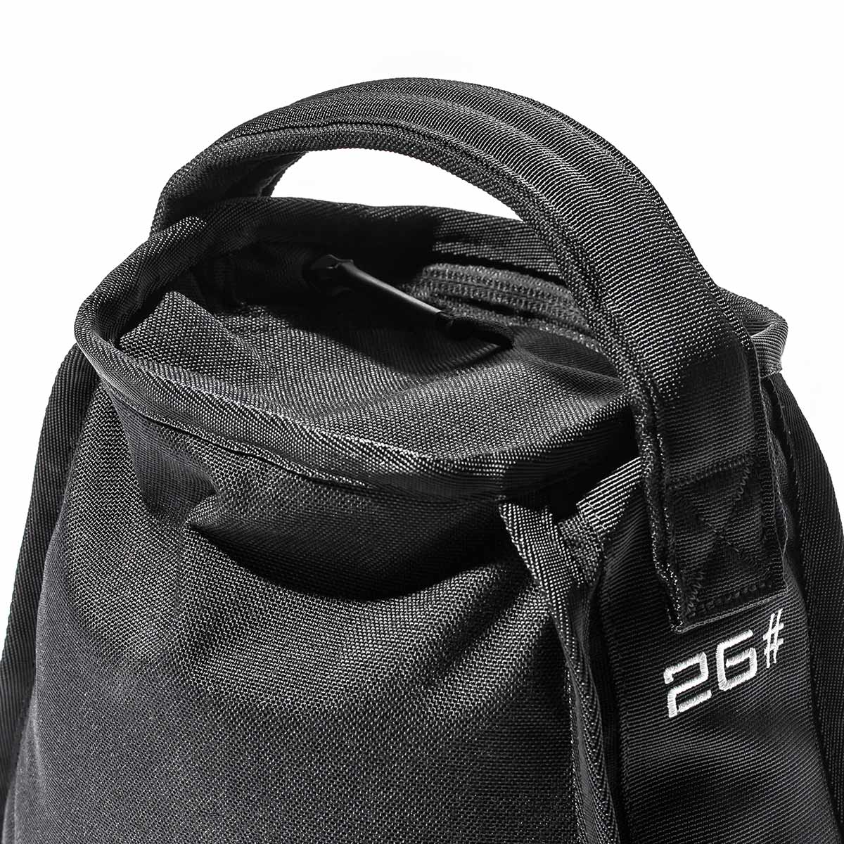 Close-up of a black fabric bag with a handle, featuring 