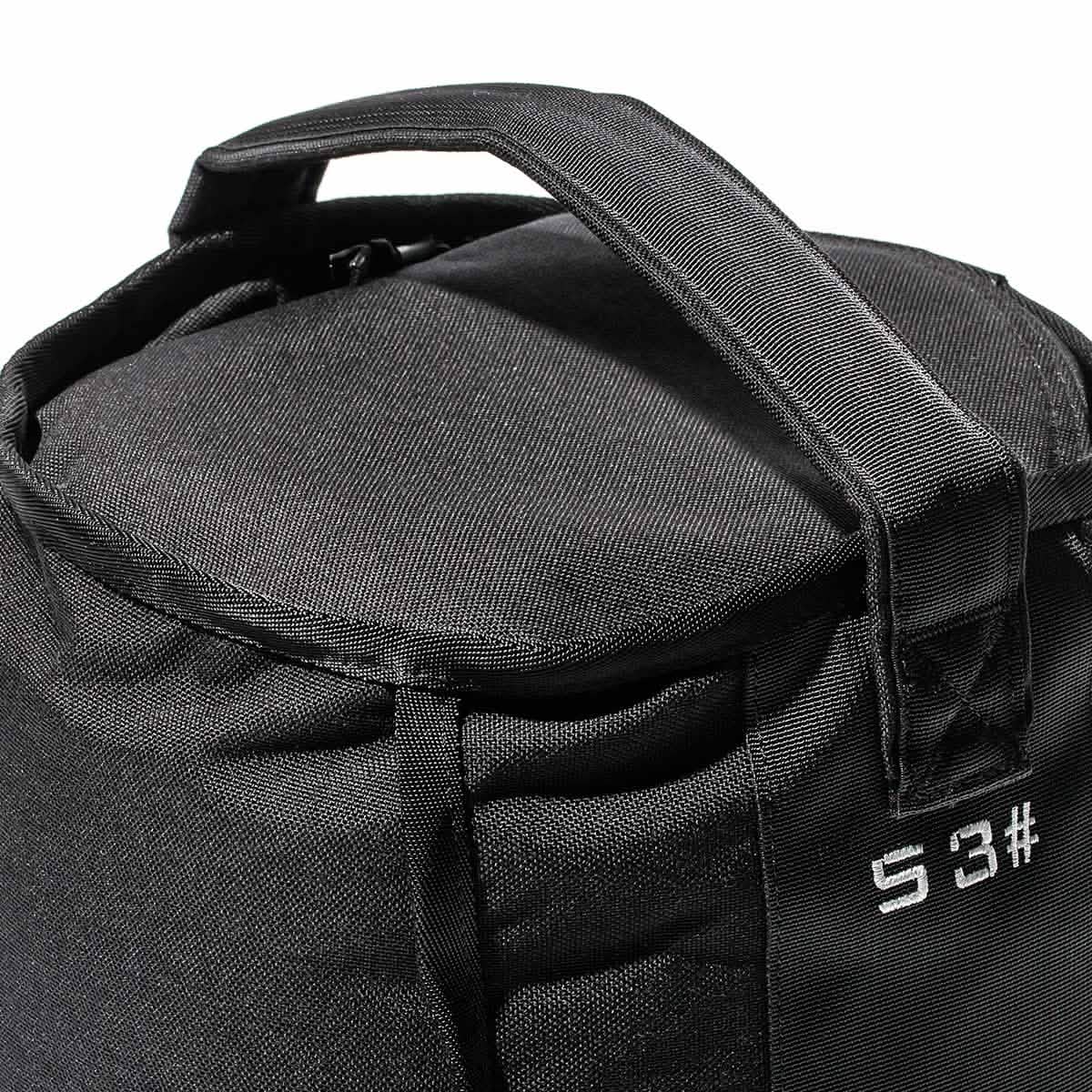 Close-up of a GORUCK Sand Kettlebell - 53LB (24KG), a black fabric bag with two handles and white text 