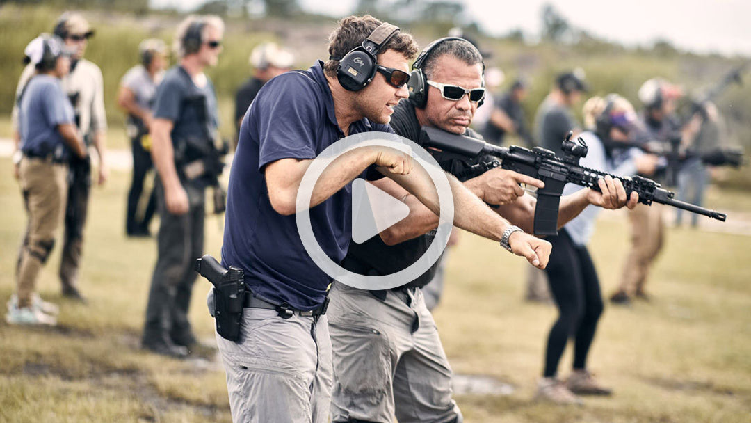 A group of men shooting guns.
