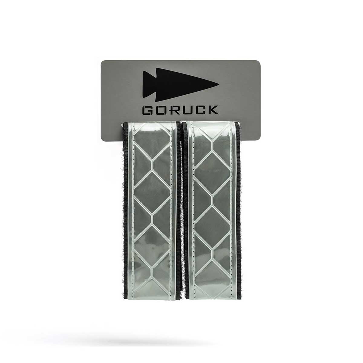 The Reflective Ruck Bands, featuring a geometric pattern for improved nighttime visibility, are sold as two Velcro straps on a GORUCK branded card.