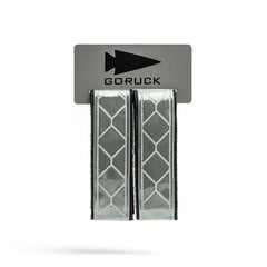 The Reflective Ruck Bands, featuring a geometric pattern for improved nighttime visibility, are sold as two Velcro straps on a GORUCK branded card.