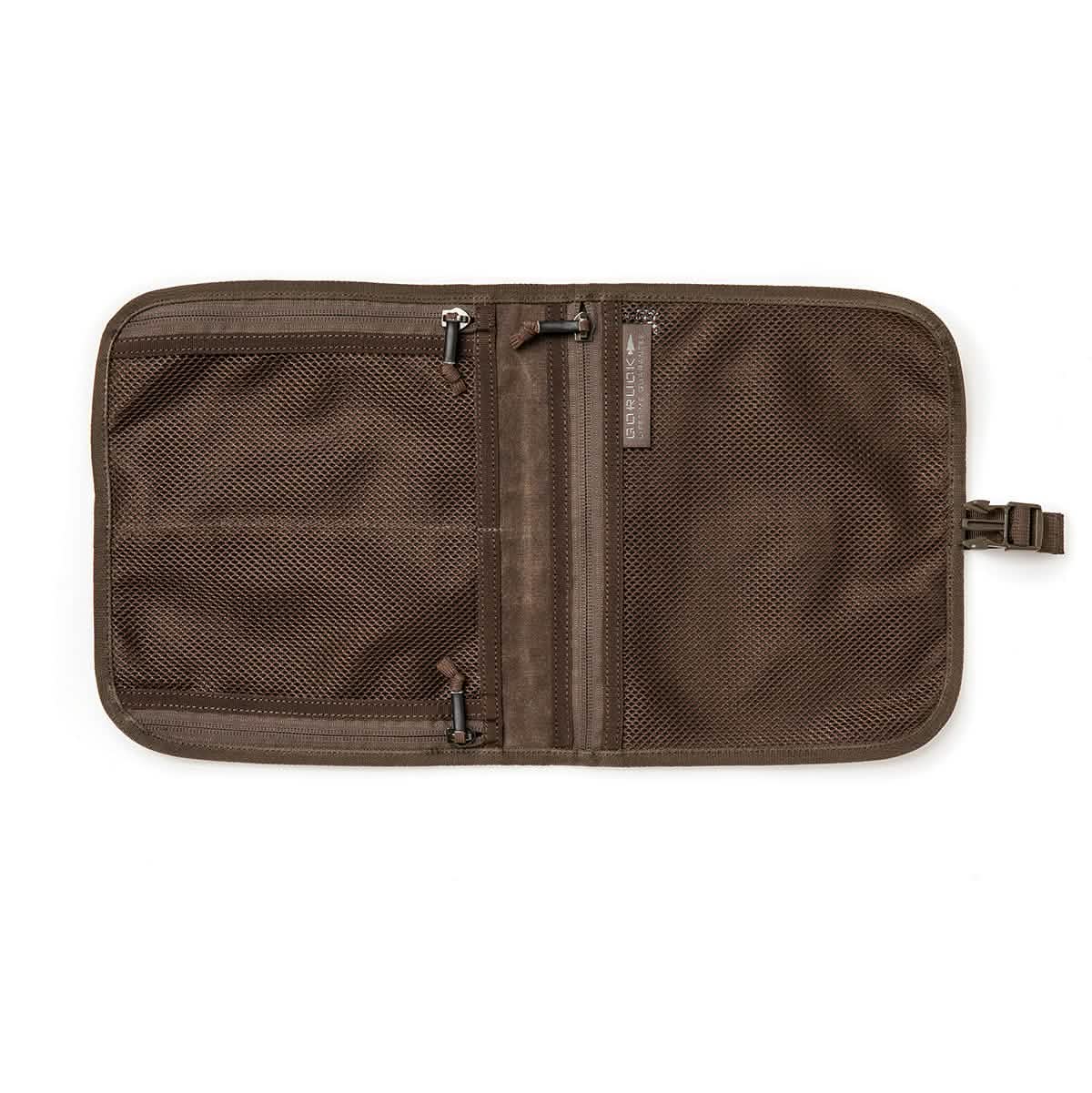 The GORUCK Wire Dopp - Waxed Canvas travel organizer features mesh zippered pockets and lies open for easy EDC and travel essentials organization, keeping your gear neatly arranged on the go.